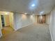 View of a finished basement area with carpeted floors and access to the laundry room at 305 Rampart St, Mcdonough, GA 30253
