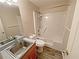 Bathroom with a shower-tub combination, a vanity with stainless steel faucet, and wood-look flooring at 305 Rampart St, Mcdonough, GA 30253