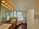 Bathroom featuring double sinks, a soaking tub, and a glass-enclosed shower, offering a spa-like experience at 305 Rampart St, Mcdonough, GA 30253