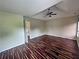 Bright bedroom with wood floors, ceiling fan and doorway leading out of the room at 305 Rampart St, Mcdonough, GA 30253