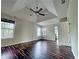 Large bedroom with wood floors, multiple windows for natural light, and ceiling fan at 305 Rampart St, Mcdonough, GA 30253