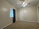 Bedroom featuring a window, a ceiling fan, neutral walls, and a closet at 305 Rampart St, Mcdonough, GA 30253