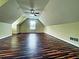 Large bonus room featuring a unique ceiling, hardwood floors, and a ceiling fan at 305 Rampart St, Mcdonough, GA 30253