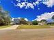 Street view showing a two-story house with gray siding and a detached garage at 305 Rampart St, Mcdonough, GA 30253