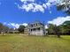 Two-story house with gray siding, brick accents, and a large yard at 305 Rampart St, Mcdonough, GA 30253