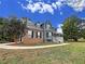 Two-story house with gray siding, brick accents, and a walkway at 305 Rampart St, Mcdonough, GA 30253