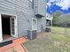 Exterior rear view of a two-story home with deck, backyard, and HVAC at 305 Rampart St, Mcdonough, GA 30253