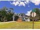 Two-story house with gray siding, brick accents, and a detached garage at 305 Rampart St, Mcdonough, GA 30253