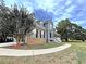 Charming two-story house with brick accents, a covered front porch, and well-manicured landscaping at 305 Rampart St, Mcdonough, GA 30253