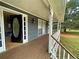 Inviting front porch with wooden deck and access to the front door at 305 Rampart St, Mcdonough, GA 30253