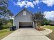 Spacious garage with painted floor and ample storage at 305 Rampart St, Mcdonough, GA 30253