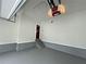 Spacious garage with painted floor and stairs leading to the house at 305 Rampart St, Mcdonough, GA 30253