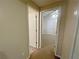 Hallway leading to a bedroom and bathroom with neutral paint at 305 Rampart St, Mcdonough, GA 30253