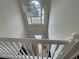 Bright hallway with a high ceiling, a chandelier and a large window at 305 Rampart St, Mcdonough, GA 30253