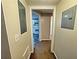Hallway leading to kitchen with electrical panels on walls and carpeted floors for comfort at 305 Rampart St, Mcdonough, GA 30253