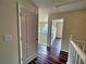 Upstairs hallway with hardwood-style floors leading to bedrooms and common areas at 305 Rampart St, Mcdonough, GA 30253