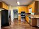Bright kitchen with stainless steel appliances, wood cabinets, and unique flooring at 305 Rampart St, Mcdonough, GA 30253