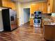 Well-lit kitchen featuring stainless steel appliances and wooden cabinets at 305 Rampart St, Mcdonough, GA 30253