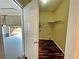 View of the laundry room with wood floors through a doorway leading to the garage at 305 Rampart St, Mcdonough, GA 30253