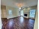 Spacious living room featuring hardwood floors, fireplace, and abundant natural light at 305 Rampart St, Mcdonough, GA 30253