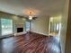 Bright living room with hardwood floors, fireplace, and access to the foyer at 305 Rampart St, Mcdonough, GA 30253