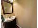 Neutral colored powder room with a traditional vanity and decorative mirror at 305 Rampart St, Mcdonough, GA 30253