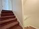 Staircase with carpet leads to the next floor, featuring a neutral wall color and white trim at 305 Rampart St, Mcdonough, GA 30253