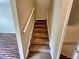Carpeted stairs with white railing, leading to the upper level of the home at 305 Rampart St, Mcdonough, GA 30253