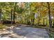 Spacious backyard with mature trees and a paved patio area at 3512 Casa Woods Ln, Clarkston, GA 30021
