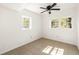 Bright bedroom with two windows and ceiling fan at 3512 Casa Woods Ln, Clarkston, GA 30021
