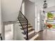 Modern entryway with hardwood floors and stylish staircase at 3512 Casa Woods Ln, Clarkston, GA 30021