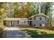 Charming two-story home featuring brick accents, gray siding, black shutters, and an attached two-car garage at 3512 Casa Woods Ln, Clarkston, GA 30021