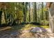 View of house from side yard showing wooded backdrop at 3512 Casa Woods Ln, Clarkston, GA 30021
