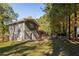 Side view of house showcasing landscaping and wooded area at 3512 Casa Woods Ln, Clarkston, GA 30021
