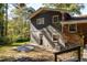 Rear view of house showing patio and wooded backyard at 3512 Casa Woods Ln, Clarkston, GA 30021