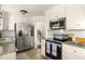Modern kitchen featuring stainless steel appliances and granite countertops at 3512 Casa Woods Ln, Clarkston, GA 30021