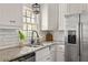 Updated kitchen with white cabinets, stainless steel appliances, and granite countertops at 3512 Casa Woods Ln, Clarkston, GA 30021