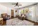 Living room with hardwood floors, leather furniture, and large windows at 3512 Casa Woods Ln, Clarkston, GA 30021