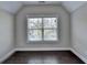 Bright bedroom featuring dark hardwood floors and a large window at 1190 Smithwell Pt, Kennesaw, GA 30152