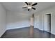 Bright bedroom with dark hardwood floors and a ceiling fan at 1190 Smithwell Pt, Kennesaw, GA 30152