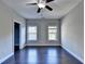 Well-lit bedroom with dark hardwood floors and two windows at 1190 Smithwell Pt, Kennesaw, GA 30152