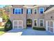 House entrance with double doors and a three-car garage at 1190 Smithwell Pt, Kennesaw, GA 30152