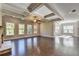 Open living room featuring hardwood floors, coffered ceilings, and natural light at 1190 Smithwell Pt, Kennesaw, GA 30152