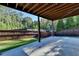Covered patio with concrete flooring and wooded backyard views at 1190 Smithwell Pt, Kennesaw, GA 30152