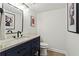 Stylish bathroom with dark vanity, marble countertop, and modern fixtures at 5371 Tall Oak Dr, Marietta, GA 30068