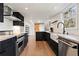 Modern kitchen boasts dark cabinetry, marble countertops, and high-end appliances at 5371 Tall Oak Dr, Marietta, GA 30068