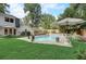 Inviting backyard pool area with ample seating and lush landscaping for relaxing and entertaining at 5371 Tall Oak Dr, Marietta, GA 30068