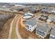 An aerial view shows the neighborhood and community pool next to walking trails and near city buildings at 6320 Halcyon Garden Dr, Alpharetta, GA 30005