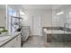 Modern bathroom with dual vanities, a luxurious soaking tub, and a separate glass-enclosed shower at 6320 Halcyon Garden Dr, Alpharetta, GA 30005