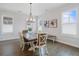 Light-filled dining room features a modern chandelier, hardwood floors, and tasteful decor at 6320 Halcyon Garden Dr, Alpharetta, GA 30005